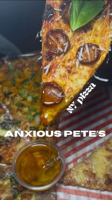 A short, energetic reel showcasing Anxious Pete's Pizza at Dockyard Social, featuring close-ups of various pizza slices and dips, along with a glimpse of the preparation process and the venue atmosphere.