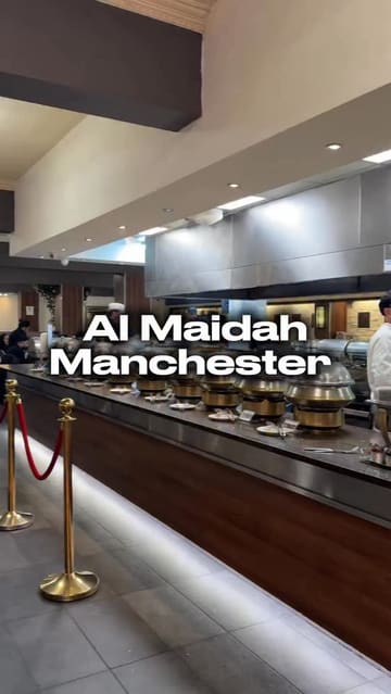 A video review of Al Maidah restaurant in Manchester, featuring a tour of the buffet selection, including various curries, starters, and desserts, with the creator providing commentary and tasting the food.