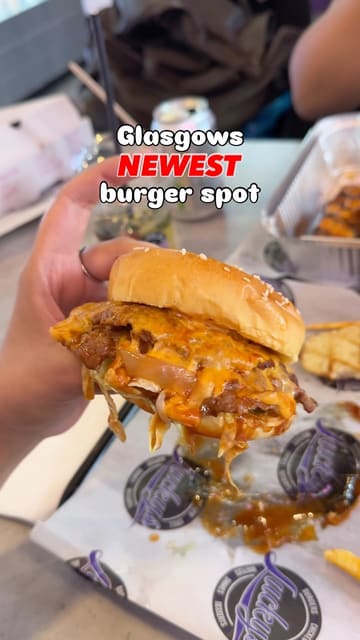 A fast-paced review of Lucky's Diner in Glasgow, featuring close-ups of a smashed burger, peri chicken platter, chocolate fudge cake, and a waffle, alongside interior shots of the venue.
