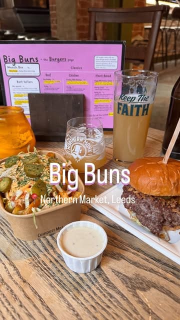 A short video showcasing a burger and loaded fries from Big Buns at Northern Market, featuring close-up shots of the food and a brief look at the venue's interior.