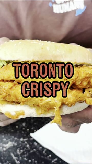 A food review video featuring two creators trying a spicy dip chicken burger and chicken strips at Toronto Crispy in Birmingham.