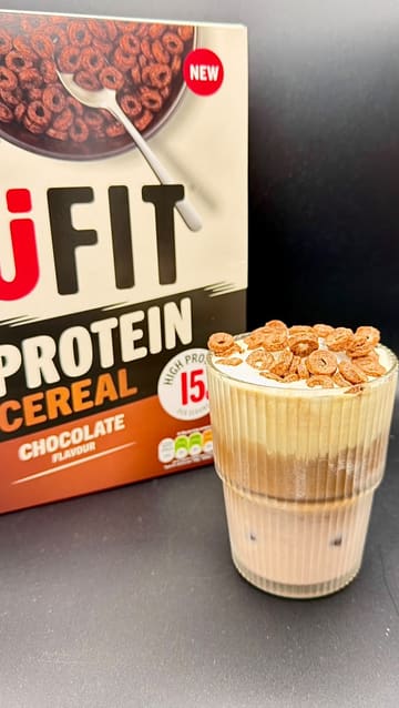 A series of quick, aesthetic shots demonstrating different ways to use UFIT protein cereal, including a cereal milk latte, a classic bowl of cereal, and a granola bowl with fruit and yogurt.