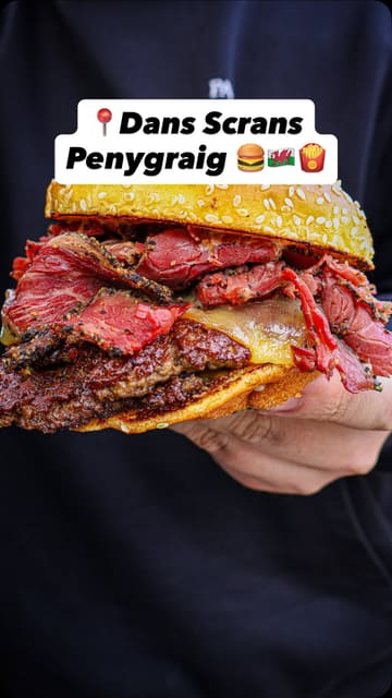 A food review of a food truck called 'Dans Scrans' in Penygraig, Wales, featuring a variety of indulgent items like a pastrami burger, a 'scran bowl' with smash burger and chicken, chorizo fries, sweet and sour chicken balls, and honey potato tots.