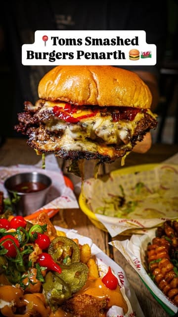 A food review of Tom's Smashed Burgers in Penarth, showcasing their burgers, loaded fries, corn ribs, and halloumi fries.