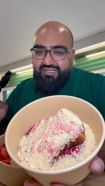 A review of The BakerBoy in Heckmondwike, focusing on their Basque cheesecake. The creator tries several flavors, including the original, raspberry ripple, chocolate crunch, and strawberry shortcake, and pairs them with a lychee mocktail.