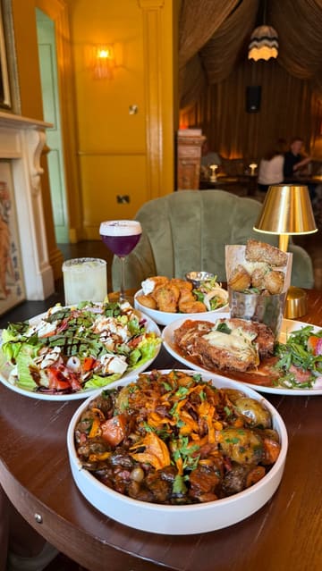 A high-quality promotional video for Margot in Belfast, featuring a montage of the venue's stylish interior, diverse menu items including salads, scampi, chicken parm, and desserts, as well as signature cocktails.