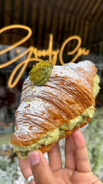 A fast-paced listicle video featuring five different bakeries in London and Liverpool, showcasing various pastries, doughnuts, and cakes with close-up shots of the food being broken open and eaten.