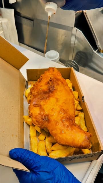 A montage-style video showcasing the food preparation and menu offerings at Jolly Rogers, a fish and chip shop in Manchester. The video features close-ups of frying fish, plating chips, and pouring gravy, alongside shots of the venue's interior decor.