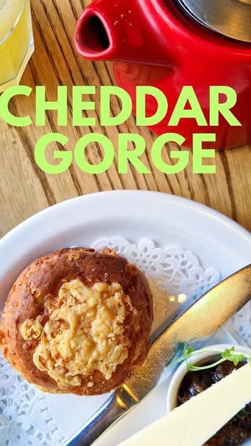 A short, engaging review of a cafe in Cheddar Gorge, highlighting their gluten-free savoury cream tea option and the scenic riverside location.