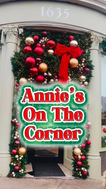 A vlog-style review of a cafe called Annie's on the Corner, featuring shots of the festive exterior, the interior, the menu, and specific brunch items like the Eggs Halloumi and Sourdough Avocado.