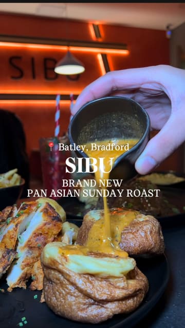 A promotional video for Sibu in Batley, showcasing their new Pan-Asian Sunday Roast menu. The video features close-up shots of various dishes, including ribeye steak and miso chicken, along with interior shots of the restaurant.
