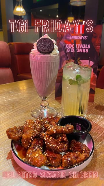 A short promotional video showcasing the 'Unlimited Sesame Chicken' offer at TGI Fridays, featuring close-up shots of the chicken, a milkshake, and a cocktail.