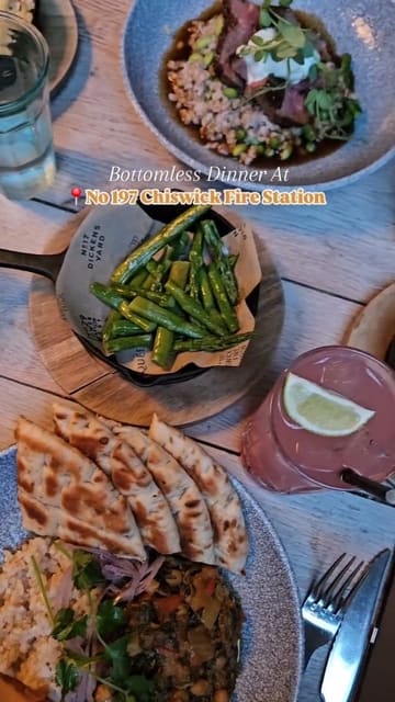 A montage of various dishes and cocktails served at No 197 Chiswick Fire Station, highlighting their bottomless dinner offering. The video features slow, steady shots of the venue's interior and close-ups of the food and drinks.