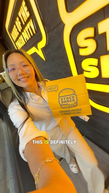 A creator visits Stack Shack to review their new menu items, specifically the paratha smash burger, injected buffalo wings, and a cola shake. The video features close-up shots of the food, the creator's reaction, and brief glimpses of the venue interior.