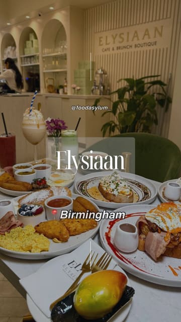 A high-quality, polished montage showcasing a variety of brunch dishes and drinks at Elysiaan in Birmingham. The video features slow-motion close-ups of food preparation and presentation, including yolk drips, syrup pours, and dessert cutting, set to music with minimal text overlays.