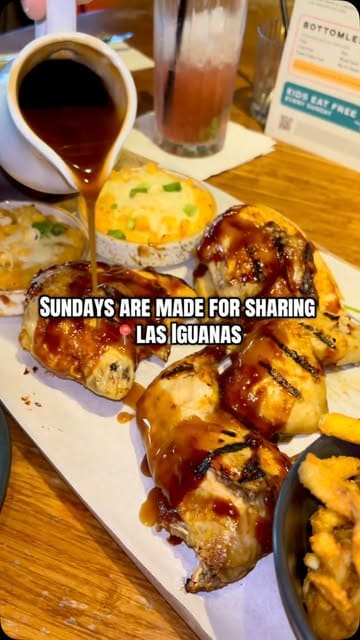 A promotional video for Las Iguanas featuring a Sunday sharing board with bottomless sides. The video highlights the food, including BBQ chicken, mac and cheese, and onion rings, while also showing the venue's atmosphere and menu details.