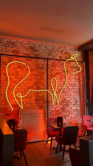 The video provides a tour of 'The Ageing Room' at The Merchant Steakhouse in Glasgow, highlighting its suitability for private dining and events. It features shots of the venue's interior, a selection of canapés including cheeseburger spring rolls, and various drinks like margaritas and wine.