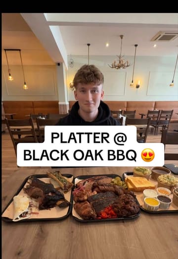 The creator visits Black Oak BBQ in Eastleigh, Southampton, to review their BBQ meat platter. The video features shots of the restaurant exterior, the smoker, and a detailed taste test of various meats including brisket, pulled ribs, and bone marrow, alongside sides like mac and cheese and Texas toast.