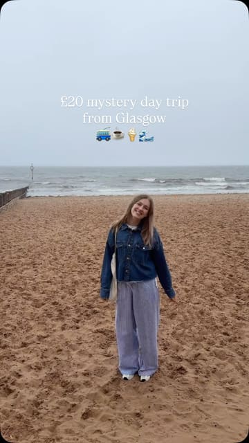 The video documents a mystery day trip from Glasgow, showcasing the bus journey, coastal scenery in Portobello and North Berwick, and stops for coffee, cake, fish and chips, and ice cream.
