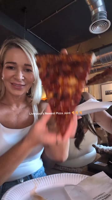 A high-energy, fast-paced reel showcasing Goldies Pizza Shop in Liverpool, featuring large New York-style pizza slices, cocktails, and a lively atmosphere with a DJ.