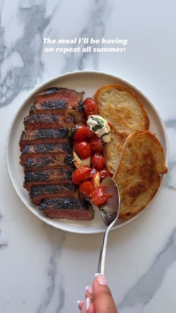 A top-down, instructional recipe video demonstrating how to prepare a steak with blistered cherry tomatoes, mozzarella, and toasted sourdough. The video uses clear, concise text overlays to guide the viewer through the cooking process.