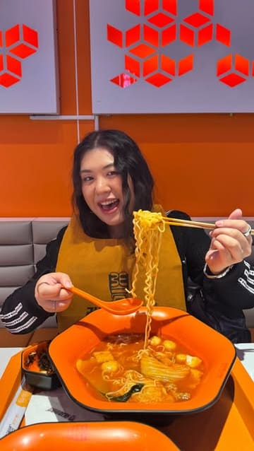 A vlog-style video showcasing the experience of dining at ZhangLiang Malatang in Glasgow, explaining the customisable 'pick your own ingredients' concept, the sauce station, and the final meal.