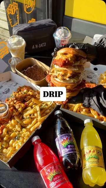 A fast-paced, rhythmic montage showcasing a variety of indulgent food items including burgers, mac and cheese, loaded fries, wings, milkshakes, and desserts from Drip, presented in large sharing boxes.