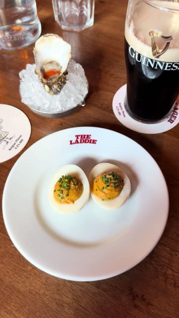 The creator visits The Highland Laddie in Leeds, providing a review of the pub's atmosphere, menu, and specific dishes including vindaloo deviled eggs, a Highland beef burger, and an arctic roll. The video features the creator's commentary on the food and drink, offering a personal perspective on the experience.