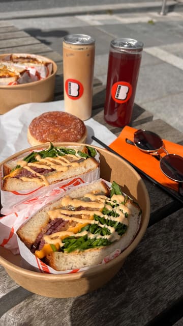 A review of a new sandwich shop called Breadwin in Newcastle, featuring a tour of the venue, a look at the menu, and a taste test of their signature sandwiches, cereal milk latte, and cereal-filled doughnut.