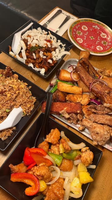 A fast-paced montage showcasing a variety of Chinese dishes at Mans Market, including a large sharing platter, duck fried rice, crispy chilli beef, and sweet and sour chicken, alongside shots of the restaurant's interior and drinks.
