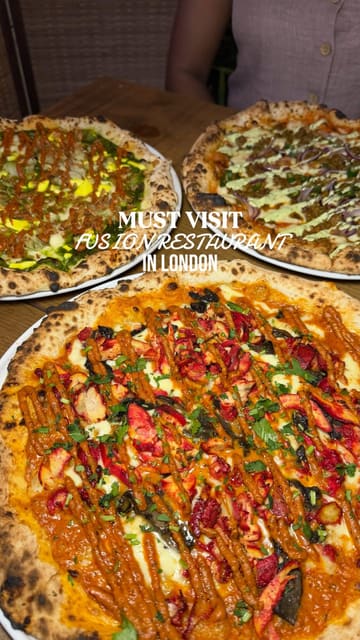 A couple visits the new Shoreditch branch of East West, a restaurant specialising in Indian-Italian fusion. The video features a variety of dishes including butter chicken arancini, saag paneer pizza, and chai tiramisu, alongside creative fusion cocktails. The content highlights the preparation process, the final presentation of the food, and the creators' enjoyment of the meal.
