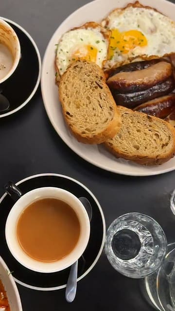 A short, visually pleasing reel showcasing a brunch visit to House of Koko in Leeds, featuring close-ups of a full English breakfast, Turkish eggs, coffee, and the venue's pastry display.