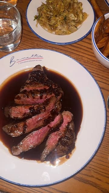 A creator visits Bavette, a neighborhood bistro in Horsforth, showcasing the interior, the open kitchen, cocktails, and a variety of dishes including steak, artichoke tart, and a chocolate dessert. The video highlights the vibrant atmosphere and the quality of the food.