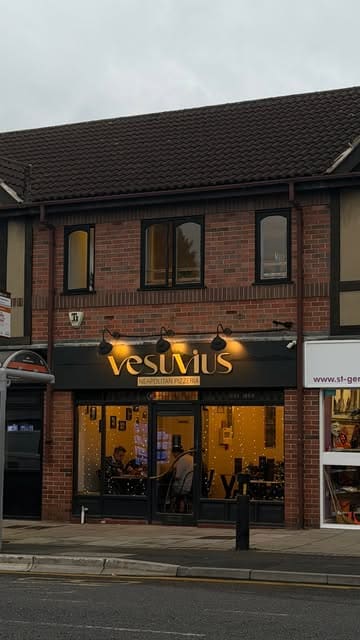 A creator reviews Vesuvius in Garforth, showcasing their starters, Neapolitan pizzas, and tiramisu dessert in a vlog-style format.