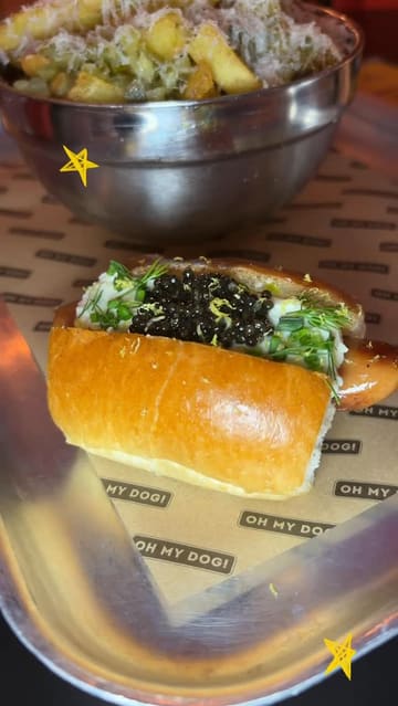 A creator visits Seven Dials Market to review the viral 'Caviar Cream Cheese Dog' from Oh My Dog. The video features a taste test of the hot dog, honey truffle fries, and a caviar sundae, providing a personal and enthusiastic review of the unique menu items.