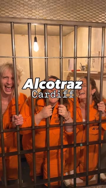 A group of friends visits Alcotraz, an immersive prison-themed cocktail bar in Cardiff, where they dress in orange jumpsuits, interact with actors playing guards and the warden, and enjoy custom cocktails served in metal mugs.