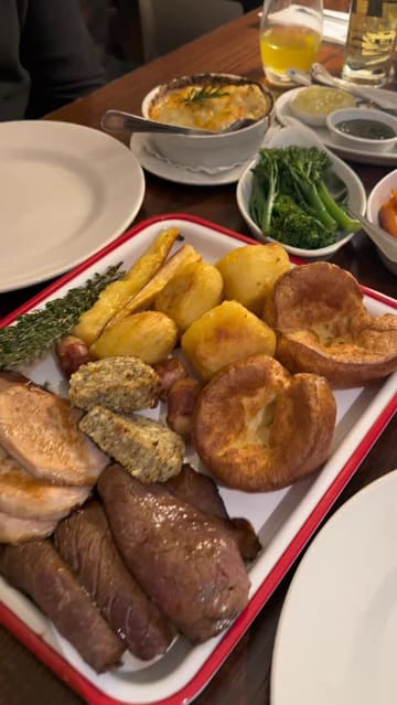A video showcasing a Sunday roast sharing platter at The Moldy Fig, featuring close-ups of the food, gravy pouring, and shots of the restaurant's interior and decor.