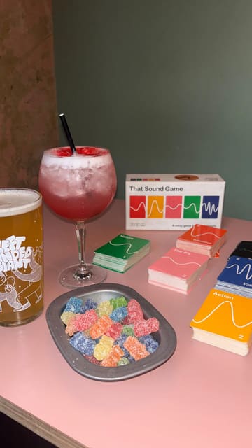 A montage video showcasing a visit to Chance & Counters, featuring shots of the venue's interior, various board games, and a selection of drinks including a boozy milkshake, a cocktail, and beer.