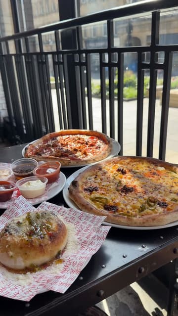 A creator visits Pizza Punks for a birthday lunch, showcasing the interior, the new menu, and several pizza and side dishes, including the 'Nduja Mac Daddy and Hardcore Carnivore pizzas, and a loaded garlic bomb.