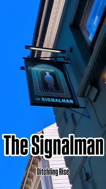 A comprehensive video tour of The Signalman pub in Brighton, highlighting its award-winning status, eclectic interior decor, sunny garden, and food menu provided by Big Sam's Kitchen.