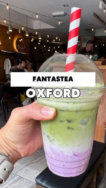 A vlog-style review of Fantastea in Oxford, highlighting their matcha drinks and variety of cakes. The creator showcases the cafe's interior, menu, and specific food items, recommending it as a spot for studying, working, or socializing.