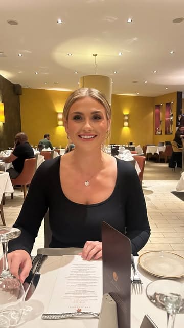 A montage video showcasing the interior and various dishes at The Radhuni restaurant in Loanhead, featuring shots of the decor, starters, curries, and naan bread.