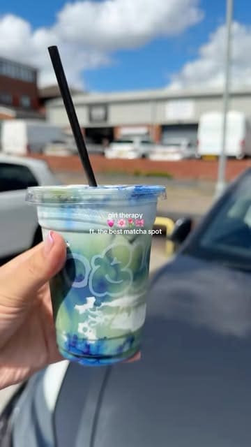 A short, energetic reel showcasing a visit to a coffee shop called Studio Black, highlighting their signature blue-layered matcha drink and pastry selection.