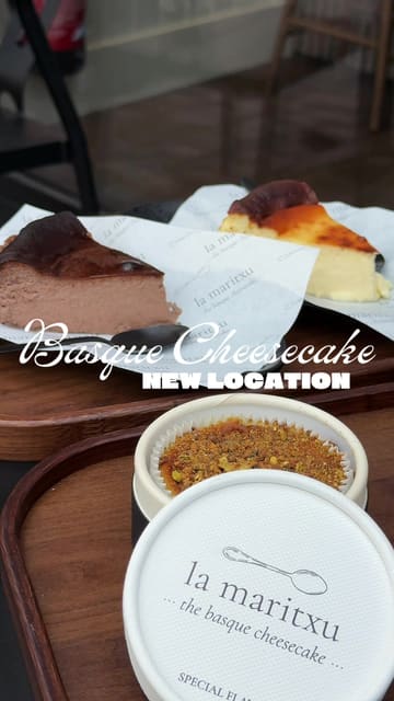 A short, aesthetic video highlighting the new location of a popular Basque cheesecake shop, featuring the original, chocolate, and pistachio flavours alongside iced coffee drinks.