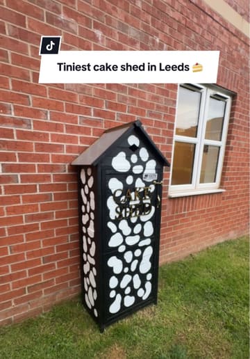 A short video showcasing a small, independent 'cake shed' in Leeds, where customers can purchase cookies and brookies. The video demonstrates the process of unlocking the shed and viewing the available treats.