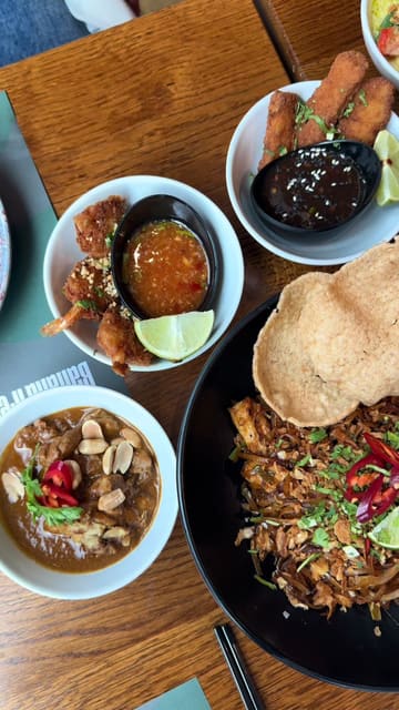 A group of friends visits Banana Tree in Cardiff to try their 'bottomless bowls' promotion during the Songkran festival. The video features shots of the restaurant interior, the menu, and the various Thai dishes they ordered, highlighting the social aspect of the meal.
