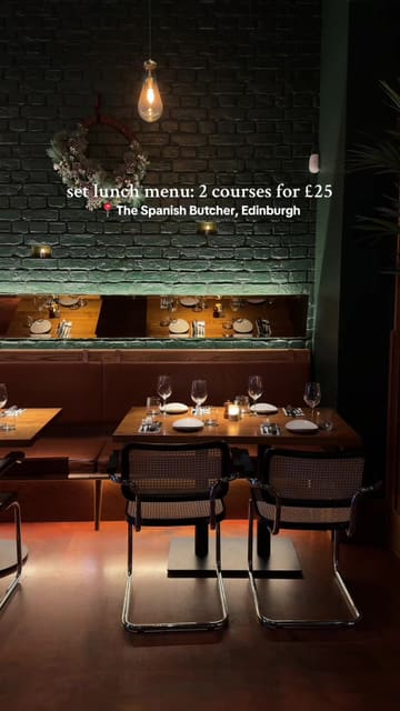 A short, edited montage showcasing the lunch menu at The Spanish Butcher in Edinburgh. The video features shots of the restaurant exterior, the interior dining area, the menu, and close-ups of dishes including charred corn, flatiron steak with fries, and green beans.