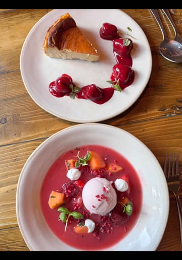 A vibrant food review showcasing the new summer menu at The Ropemakers in Emsworth. The video features close-up shots of various dishes including a scotch egg, dressed crab, a beef burger, and a strawberry-themed dessert, interspersed with glimpses of the pub's interior and exterior. The creator provides a voiceover commentary, highlighting the seasonal offerings and the value of the weekday lunch menu.