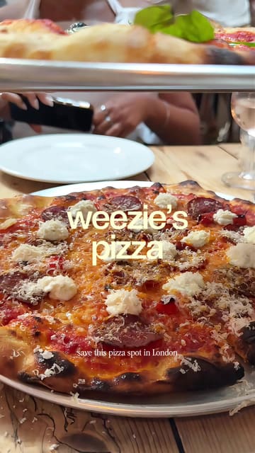 A short review of Weezies in Belgravia, highlighting the crispy pizza, loaded crisps, and chocolate mousse, while noting the no-booking policy.