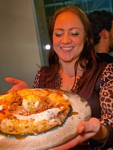 A fast-paced, engaging reel showcasing the opening of Forbici, a new pizza restaurant in Sheffield. The video features behind-the-scenes footage of pizza preparation, including the unique method of cutting pizza with scissors, as well as close-ups of various dishes like fritattina and a dessert pizza. The atmosphere is lively, and the food is presented in an appealing way.